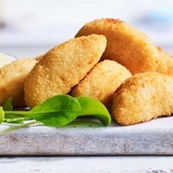 Golden crumbed chicken portions displayed on a serving board