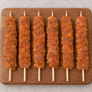 Large Oregano Chicken Kebabs 125g arranged on a wooden board