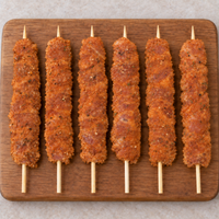 Large Oregano Chicken Kebabs 125g arranged on a wooden board