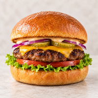 Angel Bay Gourmet Beef Burger Patty 85g served on a toasted bun with cheese, lettuce, tomato, pickles and red onion