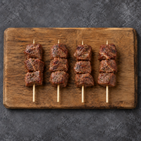 Cooked Cocktail Beef Kebabs 60g on wooden board – Triple C Poultry