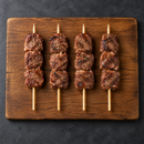 Cooked Cocktail Lamb Kebabs 60g on wooden board – Triple C Poultry