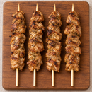 Cooked Large Oregano Chicken Kebabs 125g on wooden board – Triple C Poultry