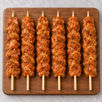 Raw Large Portuguese Chicken Kebabs 125g with Portuguese-style seasoning on wooden board – Triple C Poultry