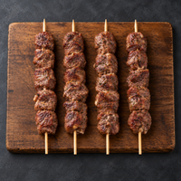 Cooked Large Spiced Lamb Kebabs 120g on wooden board – Triple C Poultry