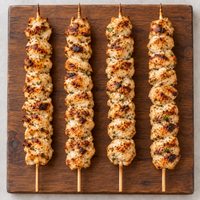 Cooked XL Mediterranean Chicken Kebabs 130g on wooden board – Triple C Poultry
